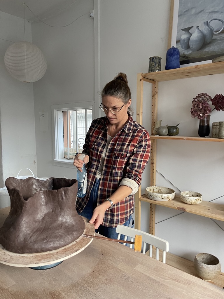 Working with clay — shaping a large form by hand